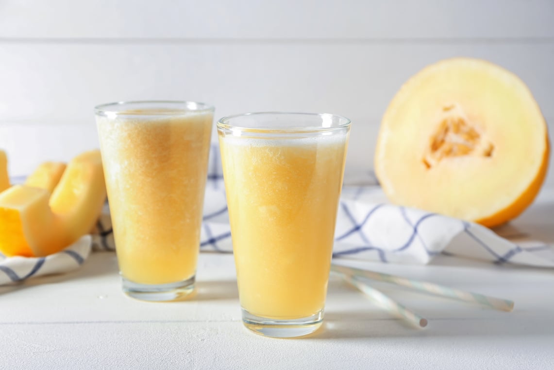 Glasses of Delicious Melon Smoothie on White Table